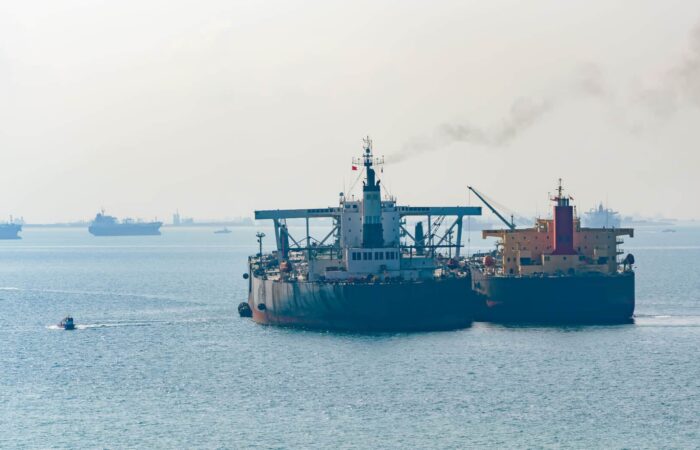 Loading anchored oil supertanker via a ship to ship oil transfer